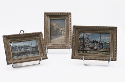 three framed pictures of boats and buildings on display on a white surface