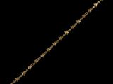 a close up of a gold star bracelet on a black background