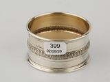 a close up of a silver ring on a white surface