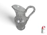 a glass pitcher with a handle on a white surface