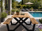 a wooden table with a bench near a pool