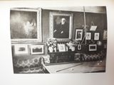 a black and white photo of a room with pictures on the wall
