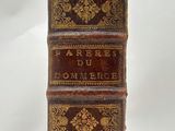 an old book sitting on top of a white surface