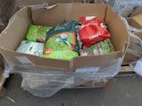 a cardboard box full of gardening supplies sitting on the ground