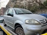 a silver car on the back of a flatbed tow truck