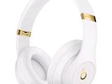 a pair of white headphones with gold accents on a white background