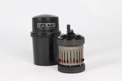 a close up of a camera lens and a canister on a white surface