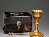 brass chalicet and box on a grey background
