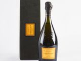 a bottle of champagne in front of a black box