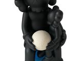 figurine de Kawshi noire tenant une balle blanche dans ses mains