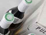 three bottles of wine that are sitting in a box
