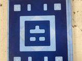 a picture of a blue and white sign on a wall