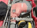 a red tool box with tools in it on a table