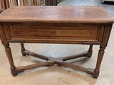 an old wooden table with a drawer on top of it