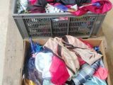 two boxes with clothes in them on a wooden table