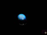 an image of a blue sphere in the dark with a black background