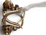 a close up of a brooch with a pearl in it