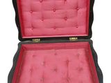 a black suitcase with a pink lining inside of it