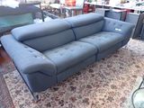 a blue couch that is sitting on a rug in a room