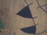 a picture of a face drawn on a burlock cloth