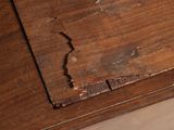 a broken piece of wood on the floor of a room