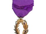 purple ribbon with a gold leaf on it and a purple ribbon with a gold leaf on it