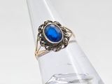 an image of a ring with a blue stone on top of a clear ring