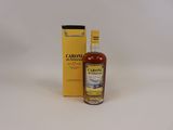 a close up of a bottle of liquor next to a box