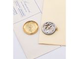 an image of a pocket watch sitting on top of a piece of paper