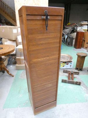 a wooden cabinet that is sitting in the middle of a room