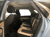the back seats of a blue car with black trims