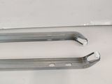 two pieces of metal are sitting on a white surface