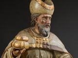 statue en bois représentant un homme portant un chapeau et une épée