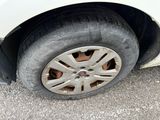 a white car that has a flat tire on it