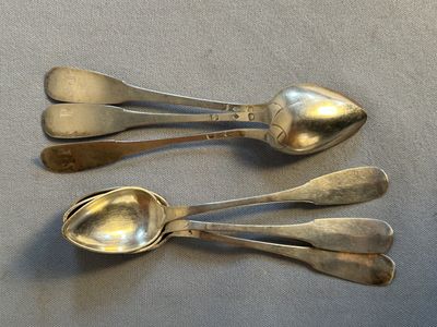 three spoons that are sitting on a table