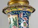 a blue vase with a gold lid on a table