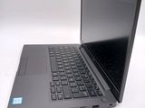 a laptop computer sitting on a white surface with a blue sticker on the screen