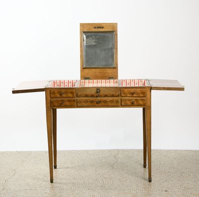 a small wooden table with a mirror on top of it