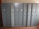 several metal lockers are lined up in a row in a room