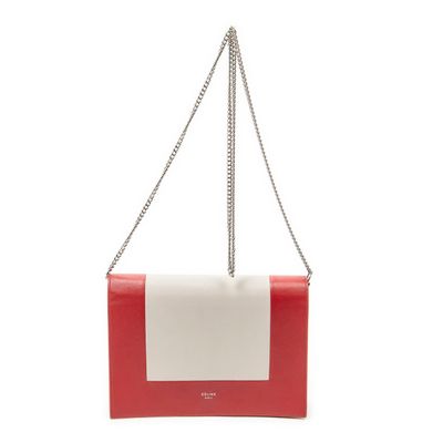 a red and white purse with a chain hanging from it