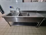 a stainless steel sink with two sinks in it