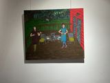 two paintings hanging on the wall of a room