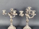 a pair of silver plated candlesticks with flowers and leaves
