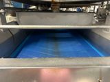 a machine that has a blue mat on it