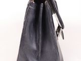 black leather handbag on a white background with a strap