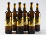 six bottles of wine are lined up on a white surface