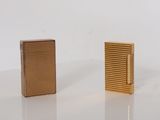 two lighters sitting side by side on a white surface