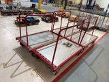 a red cart that is sitting in the middle of a room