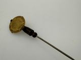 an image of a small gold coin on a stick