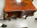 a small table with a wooden top on a floor